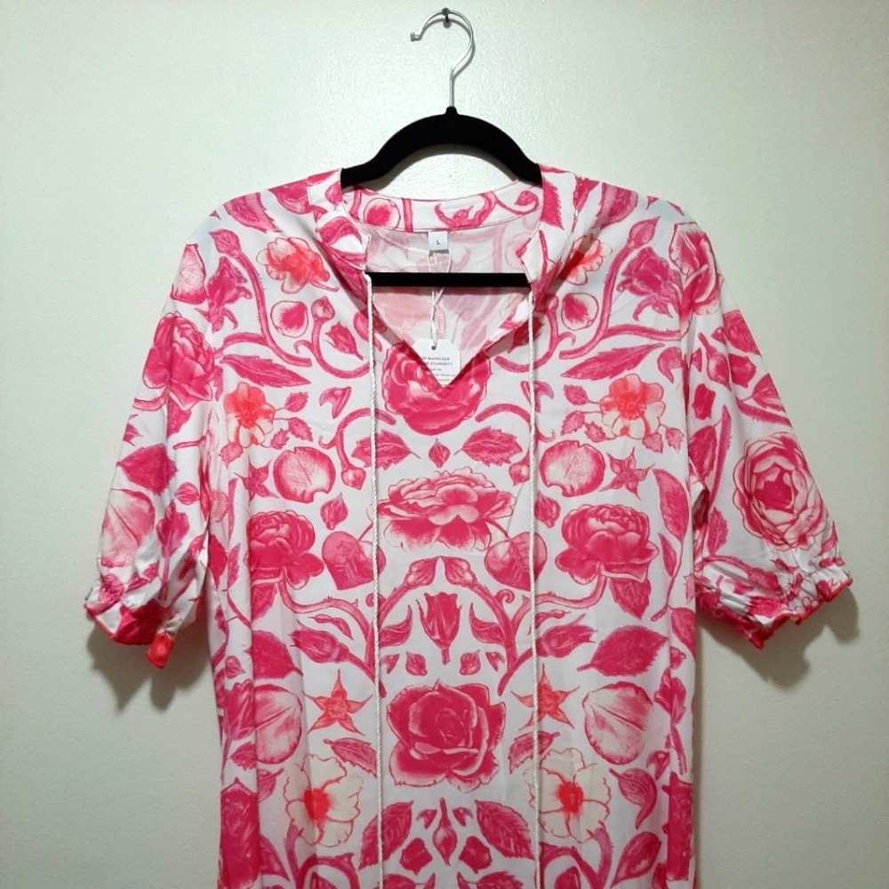 Floor length dress. White with pink flowers and white tassels.